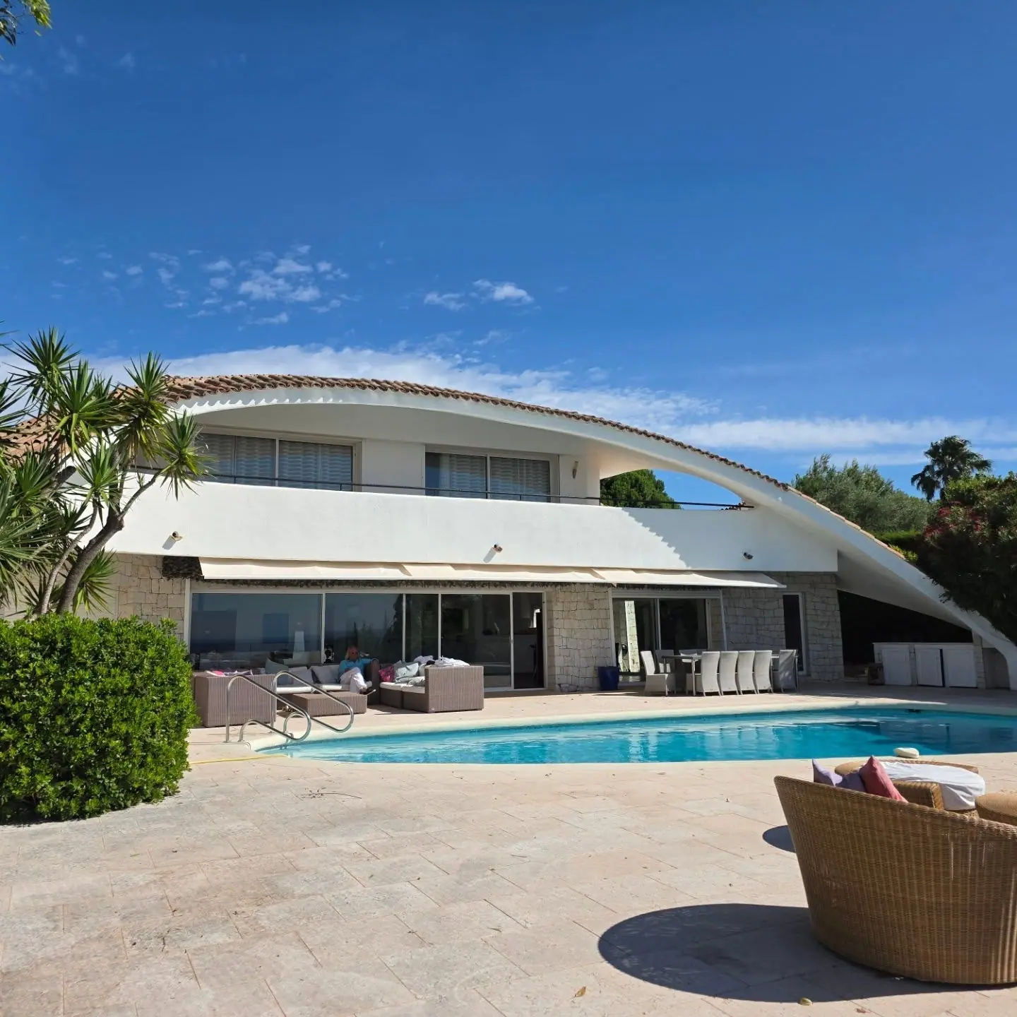 The sculptural poolside elevation beneath a clear blue sky